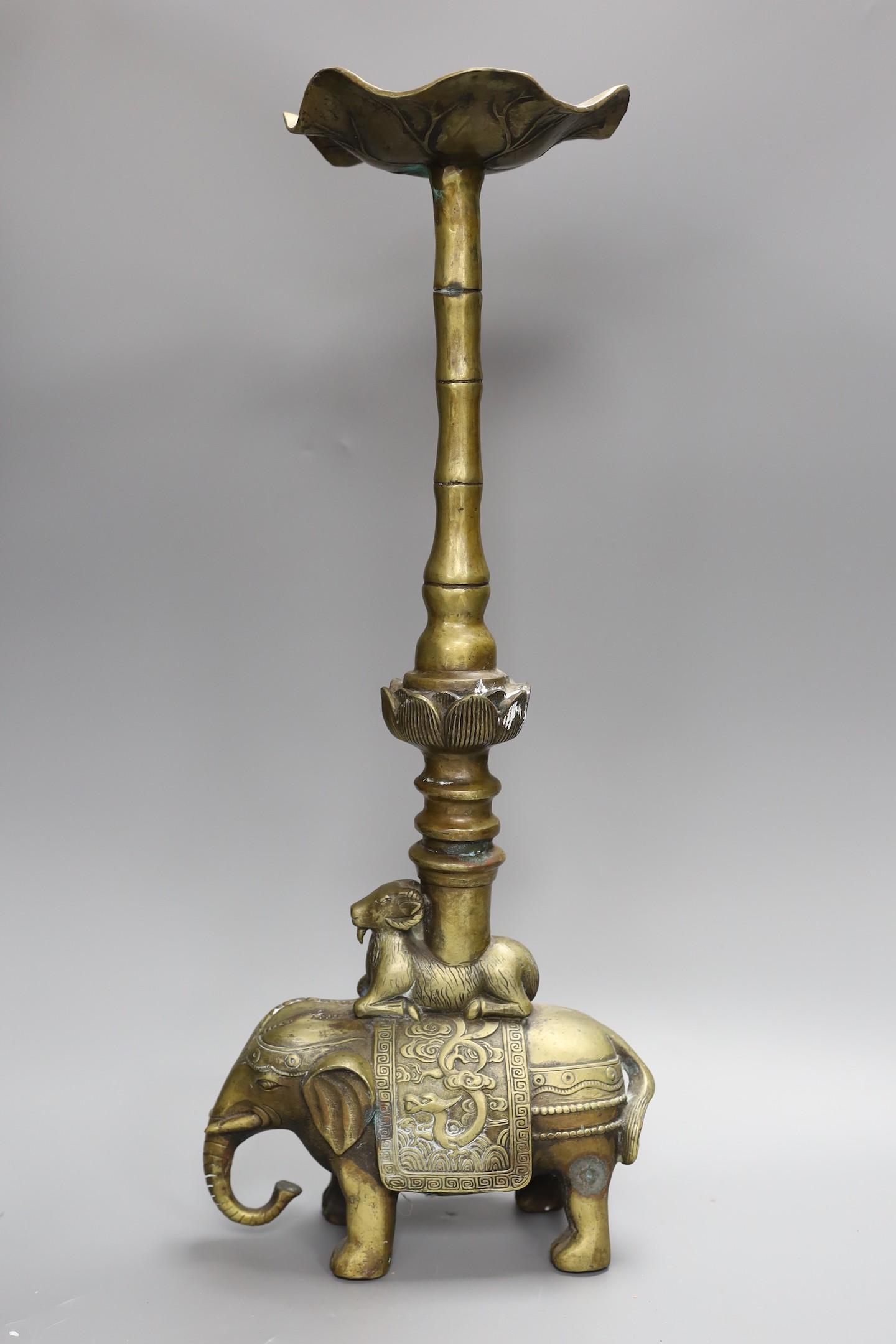 A Chinese bronze candle stand, 54 cms high